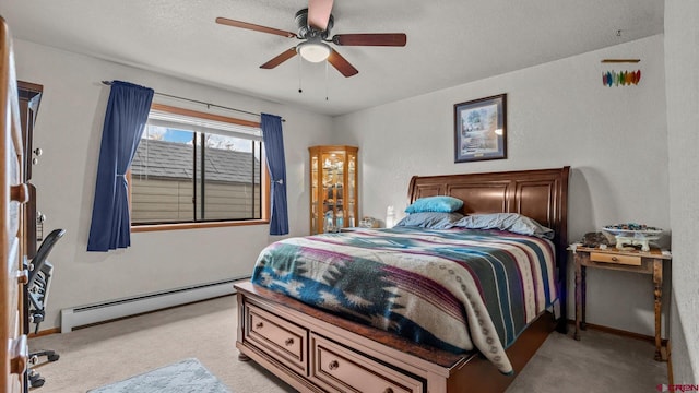 carpeted bedroom with baseboard heating and ceiling fan