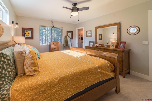 carpeted bedroom featuring ceiling fan and multiple windows