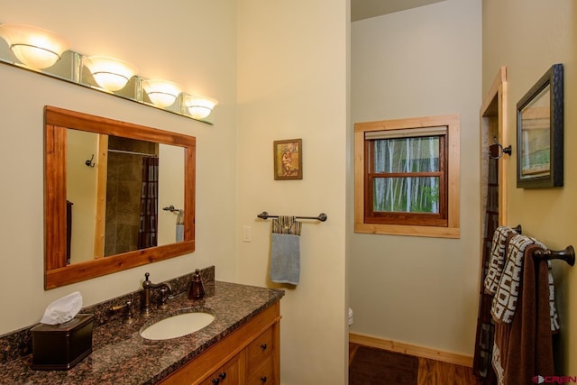 bathroom with a shower with shower curtain, vanity, and toilet