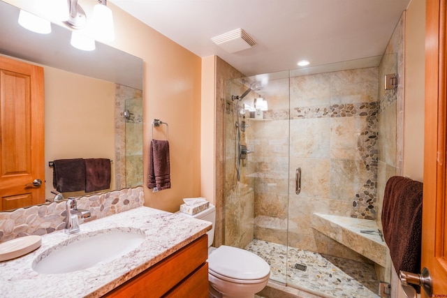 bathroom with vanity, an enclosed shower, and toilet