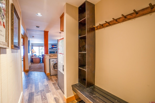 hallway featuring light hardwood / wood-style floors and washer / dryer