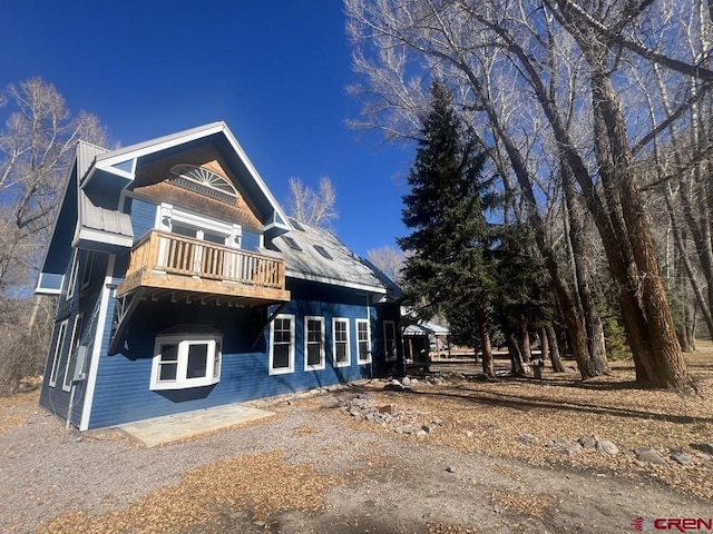 back of property featuring a balcony