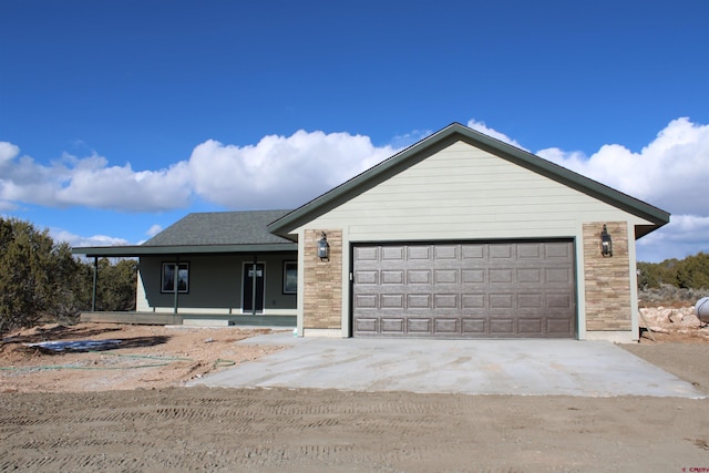 view of front of house featuring covered porch and a garage