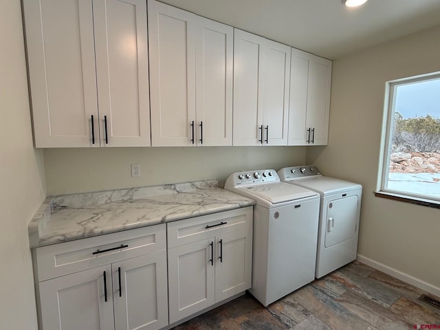 laundry area with cabinets and washing machine and dryer