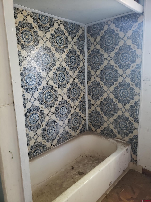 bathroom featuring a bathing tub and parquet floors