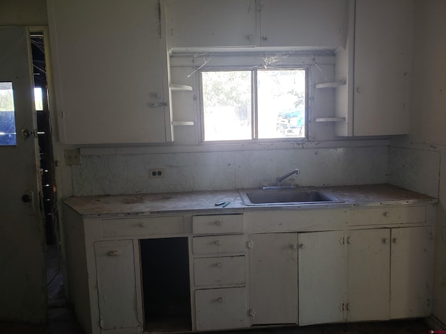 kitchen featuring sink and white cabinets