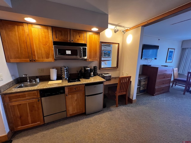 kitchen with dark carpet, sink, and appliances with stainless steel finishes