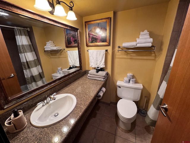 bathroom with tile patterned floors, curtained shower, vanity, and toilet