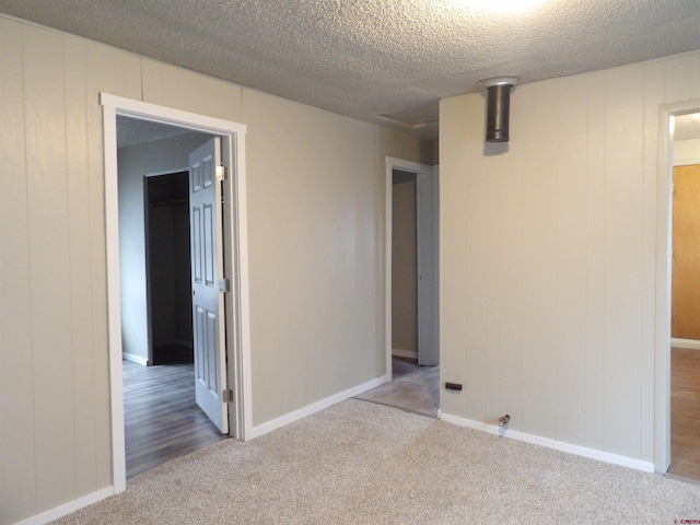 carpeted spare room featuring a textured ceiling