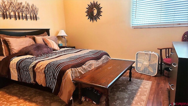 bedroom with dark wood-type flooring