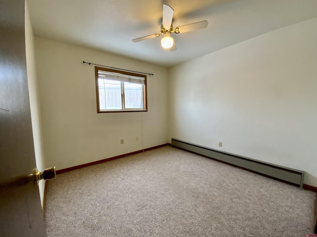 spare room with baseboard heating, ceiling fan, and carpet floors