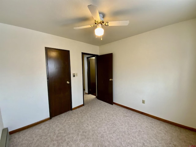 unfurnished bedroom featuring ceiling fan and light carpet