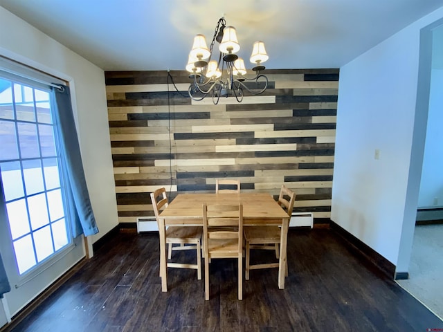 dining space with wooden walls, dark hardwood / wood-style flooring, a baseboard heating unit, and a notable chandelier