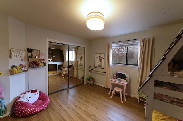 miscellaneous room with a fireplace, light hardwood / wood-style flooring, and a healthy amount of sunlight