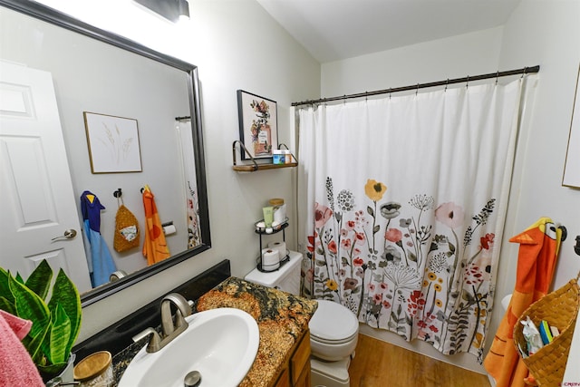 bathroom featuring hardwood / wood-style floors, vanity, toilet, and a shower with curtain