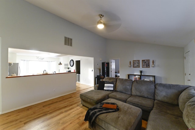 living room featuring light wood-type flooring, ceiling fan, and lofted ceiling