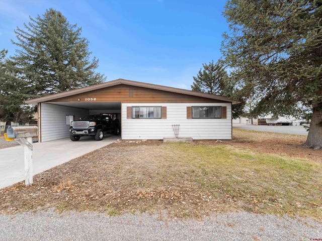 view of front of house with a front lawn and a carport