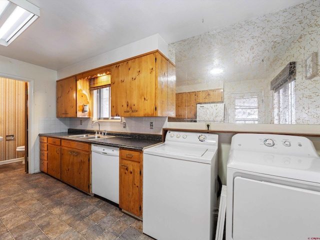 clothes washing area with washing machine and clothes dryer and sink