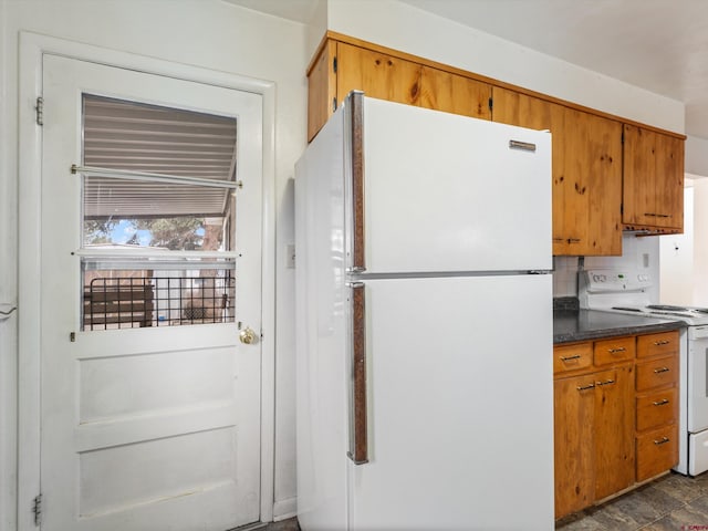 kitchen featuring decorative backsplash and white appliances