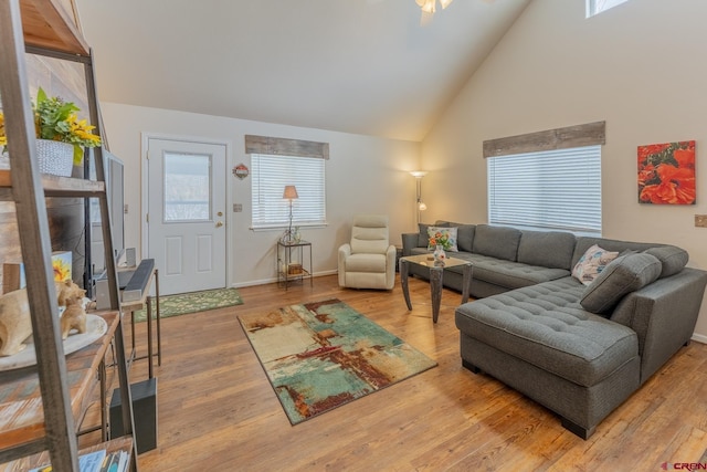 living room featuring hardwood / wood-style flooring and high vaulted ceiling