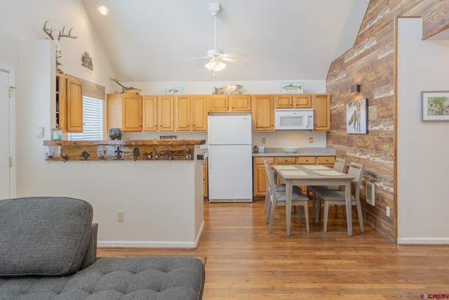 kitchen featuring ceiling fan, light brown cabinets, lofted ceiling, white appliances, and light wood-type flooring