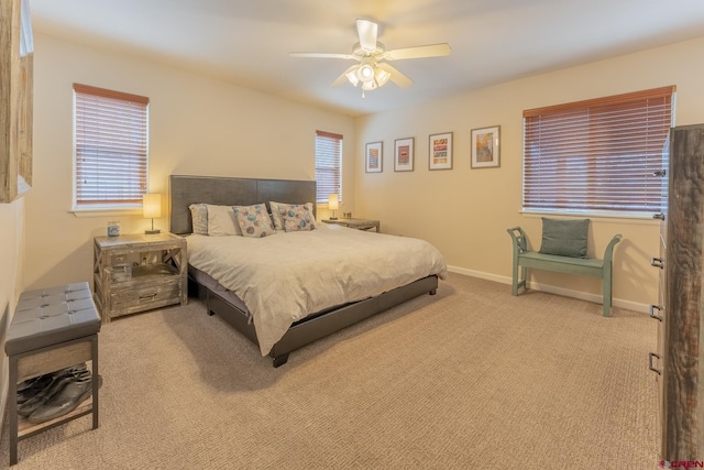 bedroom with ceiling fan and light carpet