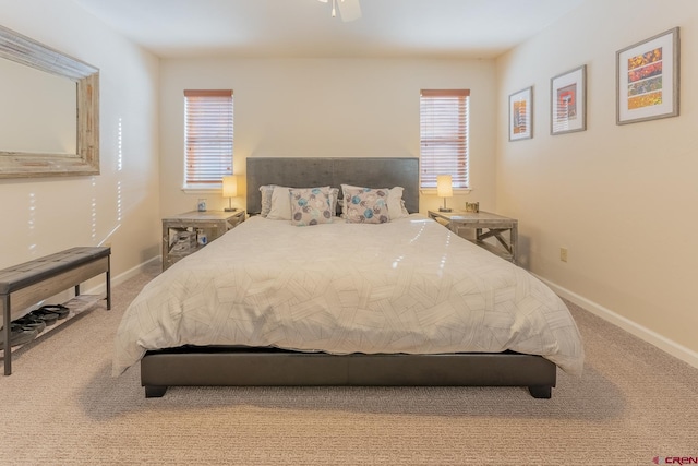 carpeted bedroom featuring multiple windows and ceiling fan