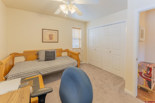 bedroom with light colored carpet, a closet, and ceiling fan