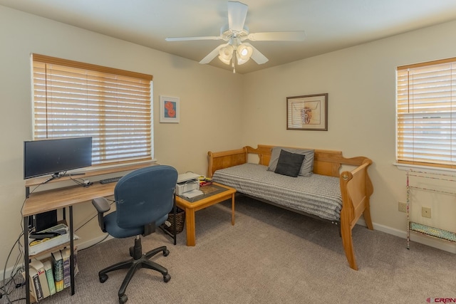 carpeted bedroom featuring multiple windows and ceiling fan