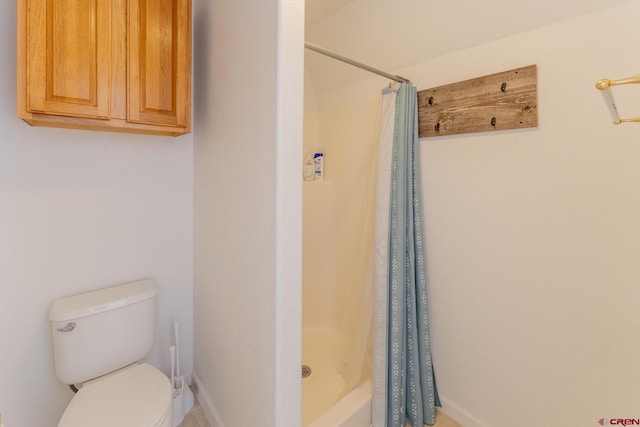 bathroom with a shower with curtain and toilet