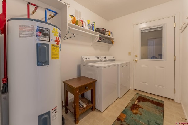 washroom featuring water heater and independent washer and dryer