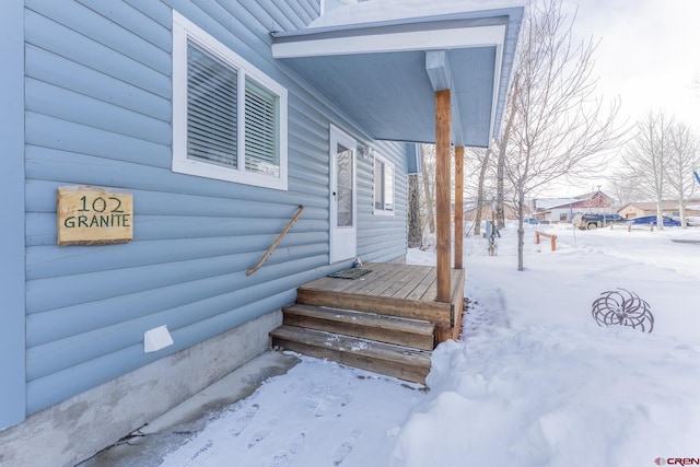 view of snow covered property entrance