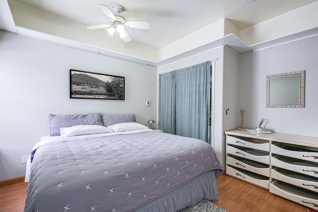 bedroom with ceiling fan and wood-type flooring