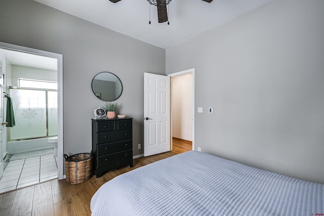 bedroom with hardwood / wood-style flooring, ceiling fan, and ensuite bath