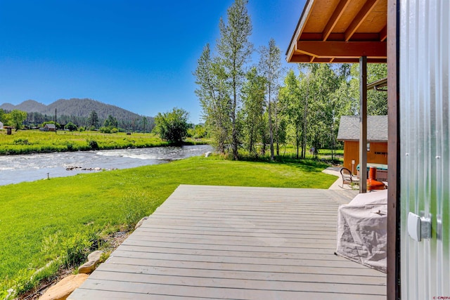 deck featuring a yard and a water and mountain view