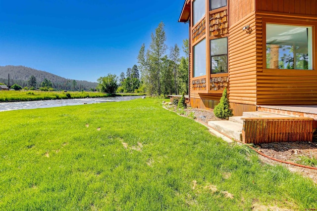 view of yard featuring a water and mountain view