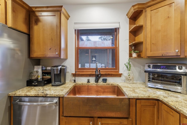 kitchen featuring light stone countertops, sink, and stainless steel dishwasher