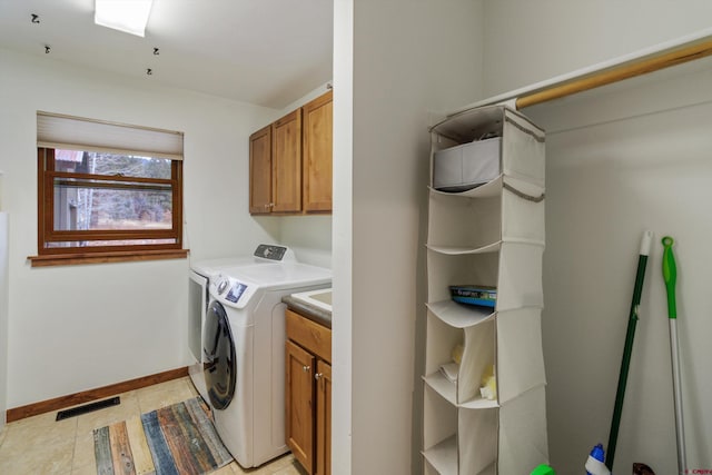 laundry area with cabinets and independent washer and dryer