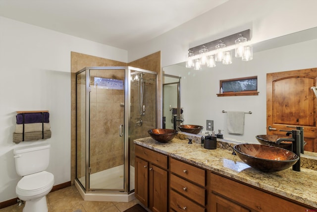 bathroom with tile patterned flooring, toilet, an enclosed shower, and vanity