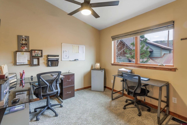 office space featuring light carpet, vaulted ceiling, and ceiling fan