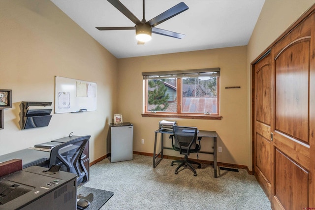 home office featuring ceiling fan, lofted ceiling, and light carpet