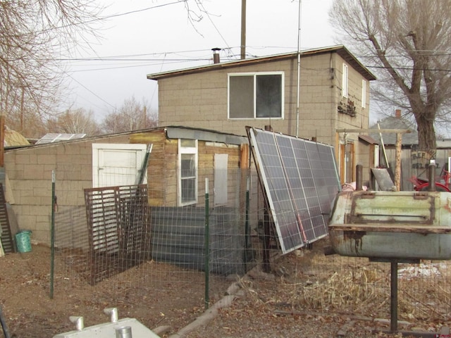 back of house with solar panels