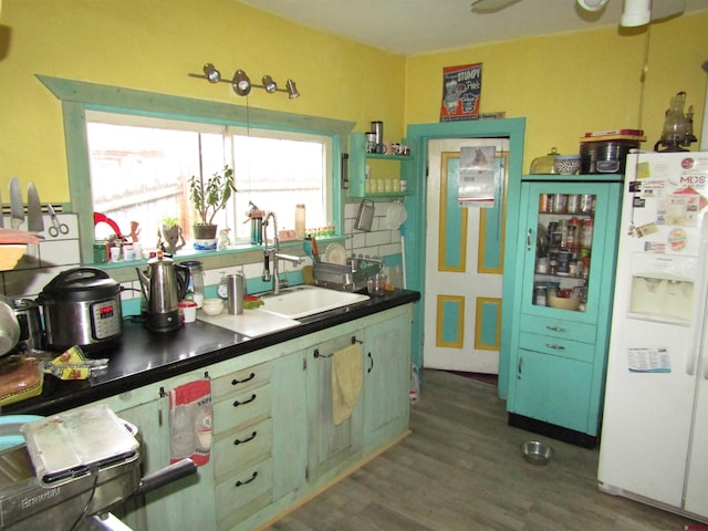 kitchen with white refrigerator, dark hardwood / wood-style floors, and sink