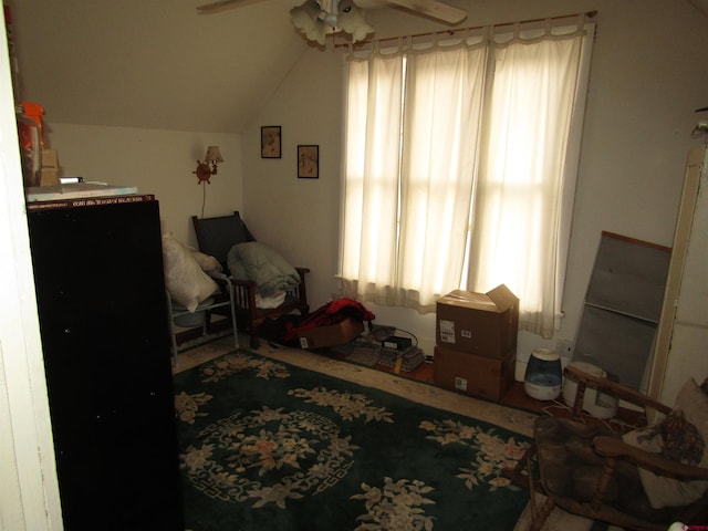 sitting room featuring ceiling fan and vaulted ceiling