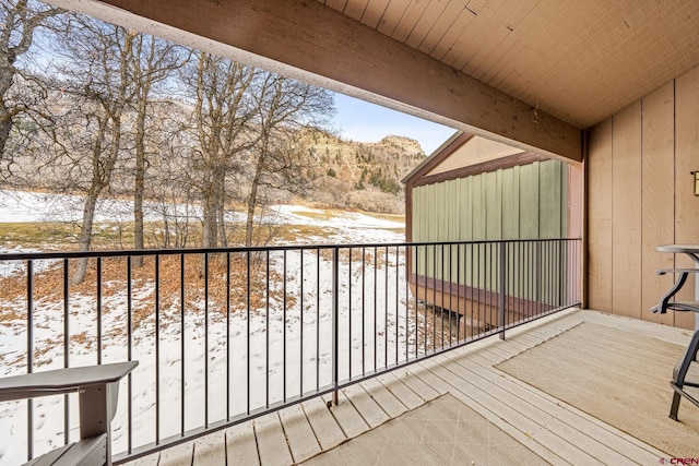 view of snow covered back of property