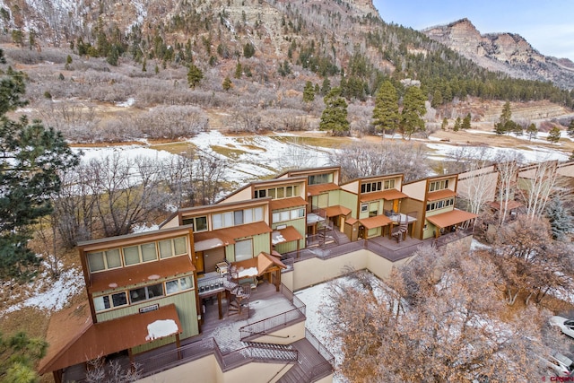 snowy aerial view featuring a mountain view