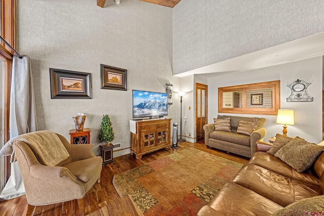 living room with dark hardwood / wood-style flooring and a high ceiling