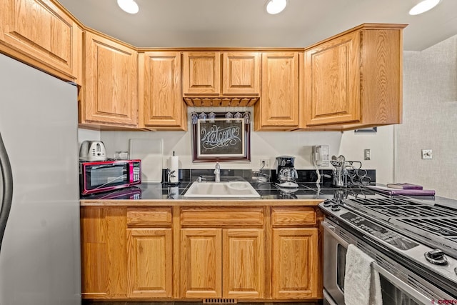 kitchen with appliances with stainless steel finishes and sink