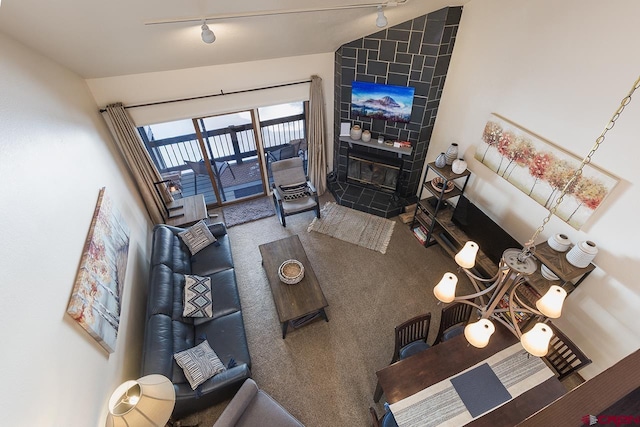 living room featuring a tile fireplace and vaulted ceiling