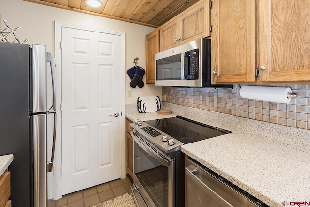 kitchen with appliances with stainless steel finishes, backsplash, ornamental molding, wood ceiling, and light tile patterned flooring